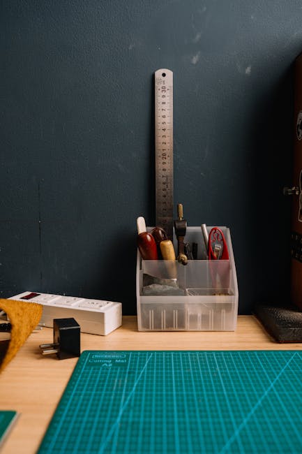 A well-organized set of tools with a cutting mat in a workshop setting.